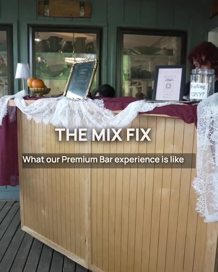 The Premium bar: the handcrafted wooden bar dressed to the event, with the signature menu framed on top.