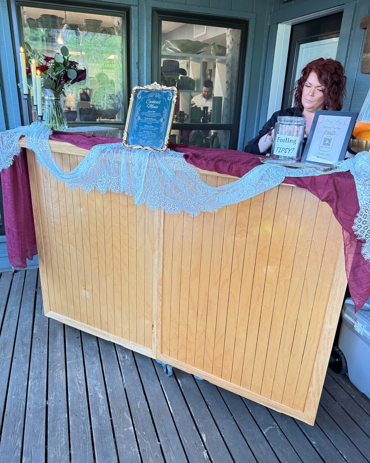 The Mix Fix wooden bar dressed in lace with the framed menu at a wedding